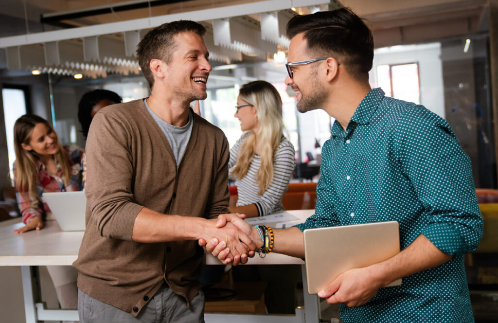 Two men shaking hands in an office